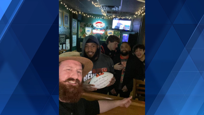 Bengals coach Zac Taylor delivers game ball to fans at a bar