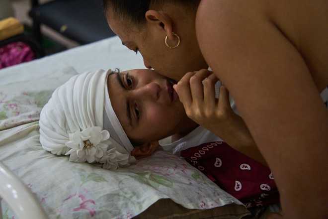 Niala Gonzalez, a cancer patient is kissed by her mother at the National Institute of Oncology and Radiology in Havana, Cuba, Friday, Feb. 20, 2026.