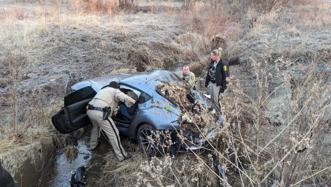 Cass county sheriff's deputies surround car that crashed after striking tire deflation devices