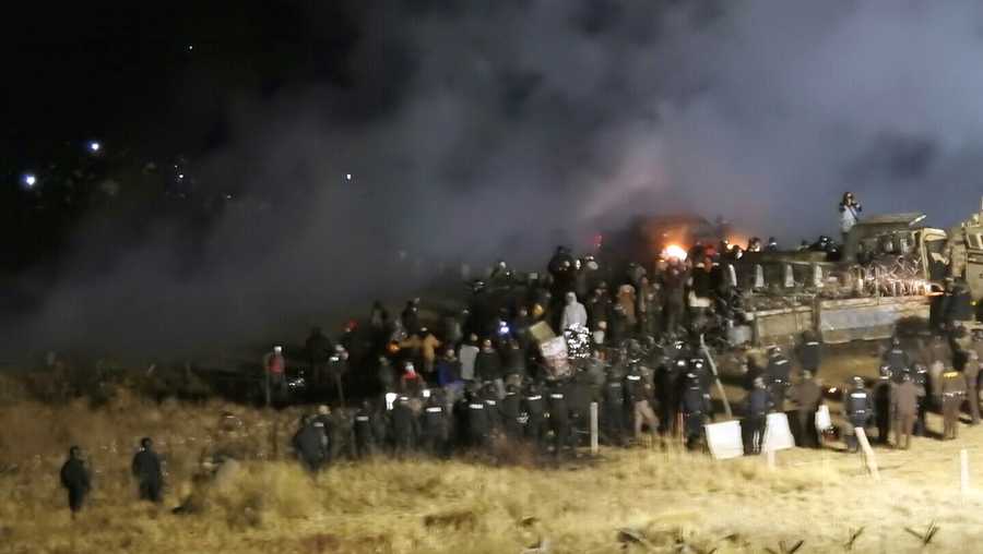 In this Nov. 20, 2016 file photo, provided by Morton County Sheriff's Department, law enforcement and protesters clash near the site of the Dakota Access pipeline on Sunday, Nov. 20, 2016, in Cannon Ball, N.D.