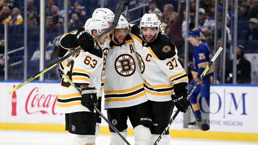 Boston Bruins' left wing Brad Marchand (63), defenseman Charlie McAvoy (73), right wing David Pastrnak (88) and center Patrice Bergeron (37) celebrate after a goal by Pastrnak during a power play during the first period of an NHL hockey game against the Buffalo Sabres on Wednesday, Nov. 24, 2021, in Buffalo, N.Y. (AP Photo)