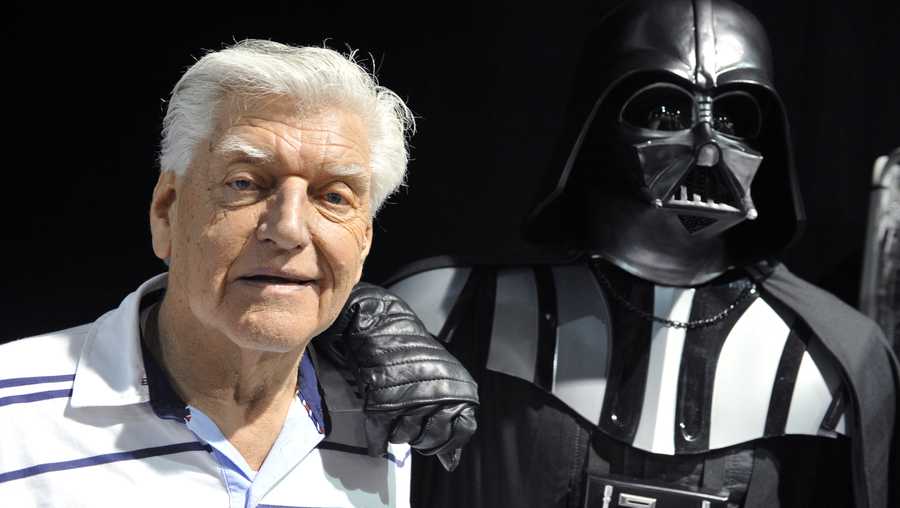 FILE: English actor David Prowse (L), who played the character of Darth Vader (Dark Vador in French) in the first Star Wars trilogy poses with a fan dressed up in a Darth Vader costume during a Star Wars convention on April 27, 2013.