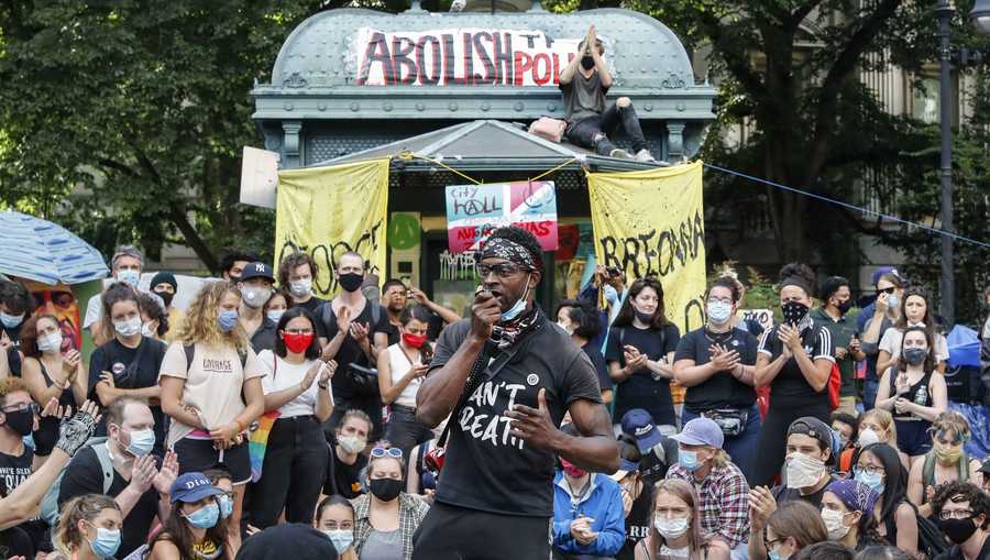 Protesters gather at an encampment outside City Hall, Tuesday, June 30, 2020, in New York. New York City lawmakers approved an austere budget early Wednesday that will shift $1 billion from policing to education and social services in the coming year.