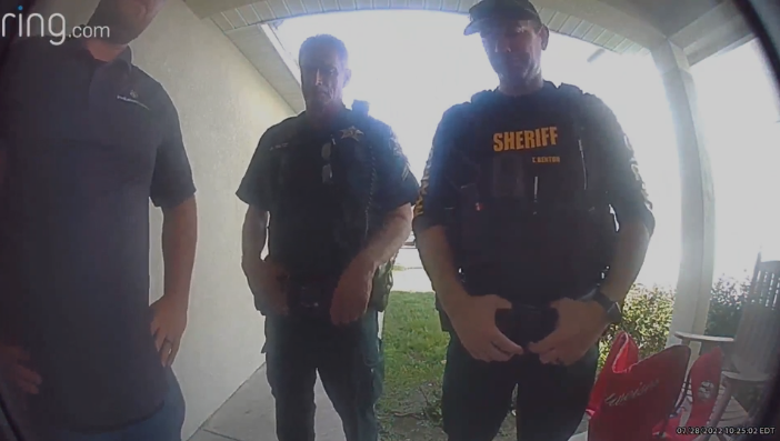 A Ring doorbell showing deputies and a locksmith outside of a home