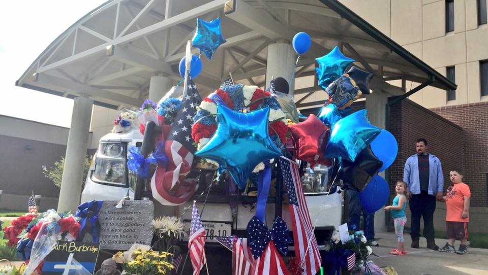 Growing memorial at fallen deputy's cruiser