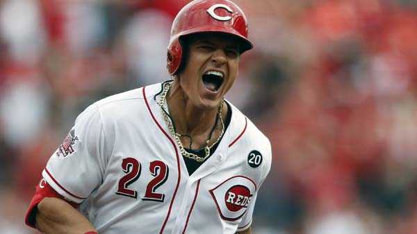 Cincinnati Reds' Derek Dietrich reacts as he runs the bases on his three-run home run off Pittsburgh Pirates relief pitcher Richard Rodriguez in the seventh inning of a baseball game, Thursday, March 28, 2019, in Cincinnati. (AP Photo/Gary Landers)