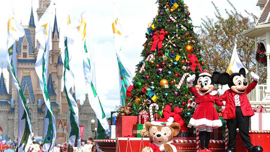 In this handout photo provided by Disney, Mickey and Minnie Mouse wave to the crowd while taping the "Disney Parks Christmas Day Parade" TV special in the Magic Kingdom park at Walt Disney World on December 1,2012 in Lake Buena Vista, Florida.