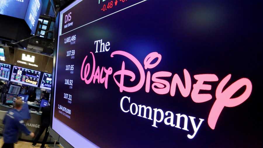 FILE - In this Aug. 8, 2017, file photo, The Walt Disney Co. logo appears on a screen above the floor of the New York Stock Exchange.