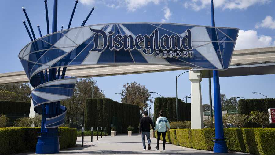 Two visitors enter Disneyland Resort in Anaheim, Calif., on March 9, 2021. Disneyland said Thursday, April 8, 2021, that its new Avengers Campus will debut on June 4, nearly a year after originally planned.