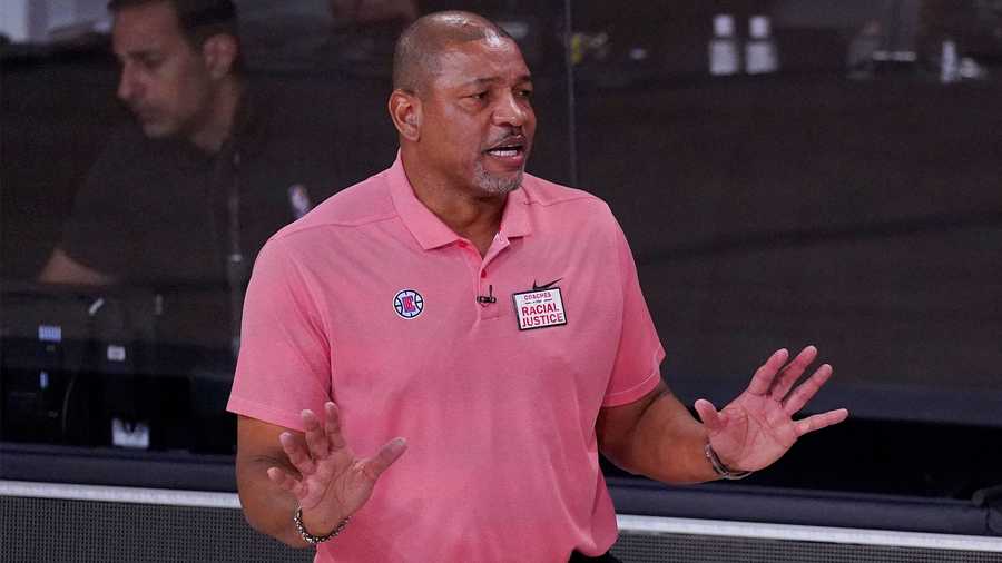 Los Angeles Clippers head coach Doc Rivers, left, questions a call during the first half of an NBA conference semifinal playoff basketball game against the Denver Nuggets, Tuesday, Sept. 15, 2020, in Lake Buena Vista, Fla. (AP Photo/Mark J. Terrill)