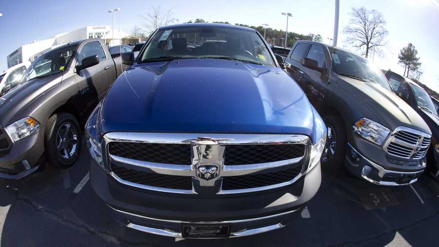 In this Jan. 5, 2015 file photo, Ram pickup trucks are on display on the lot at Landmark Dodge Chrysler Jeep RAM in Morrow, Ga.