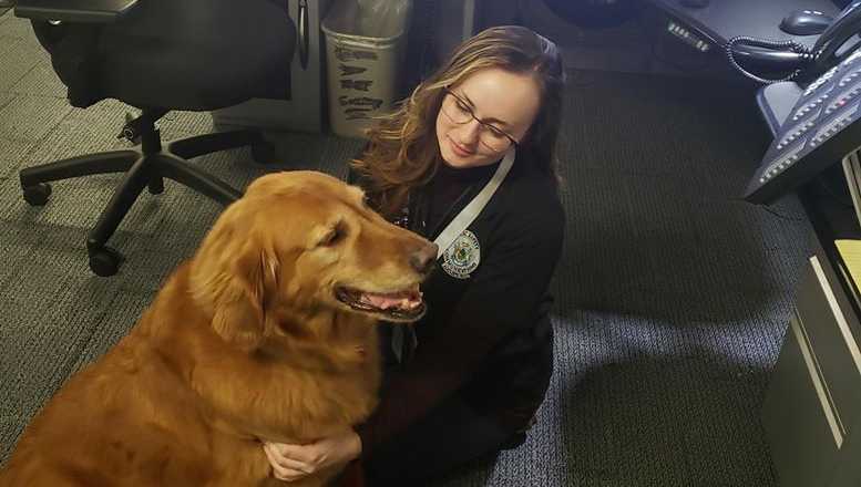 Scupper, an eleven year old golden retriever service dog, visits the Augusta dispatch center