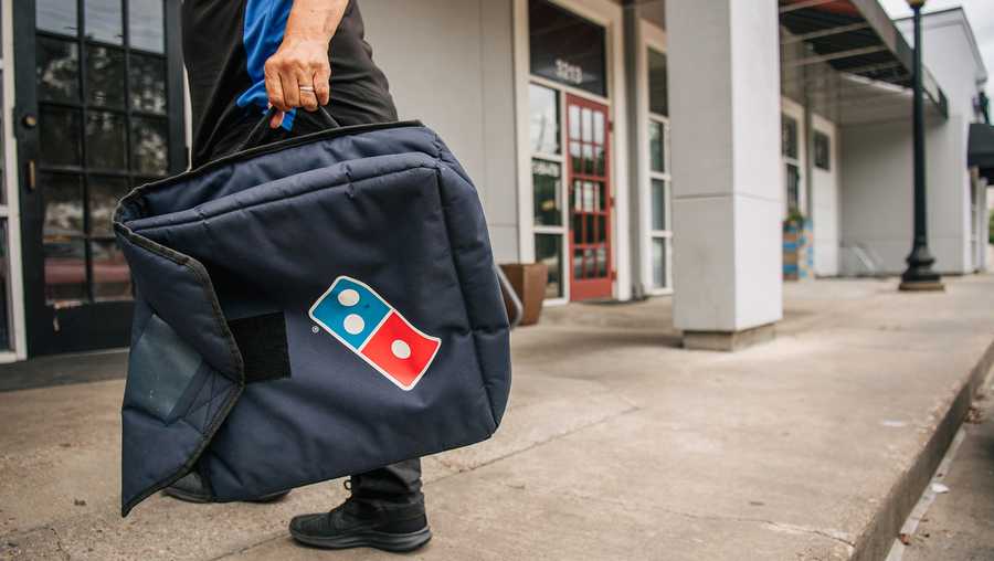 HOUSTON, TEXAS - JULY 22: A Domino's Pizza employee returns from a delivery on July 22, 2021 in Houston, Texas.