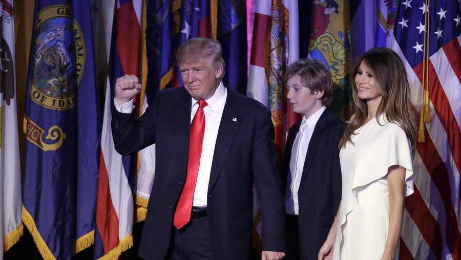 Donald Trump pumps his fist after giving his acceptance speech as his wife Melania Trump and Barron Trump follow him during his election night rally.