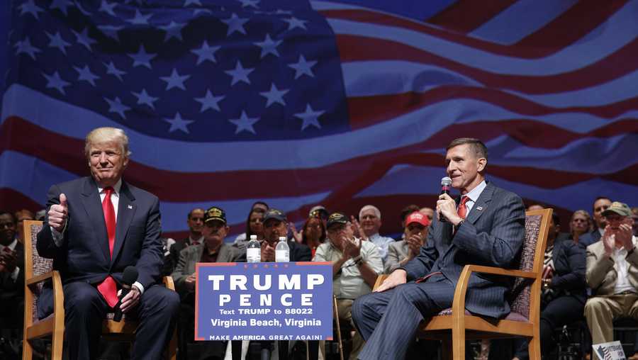In this file photo, then-Republican presidential candidate Donald Trump gives a thumbs up as he speaks with retired Lt. Gen. Michael Flynn during a town hall, Tuesday, Sept. 6, 2016, in Virginia Beach, Va.