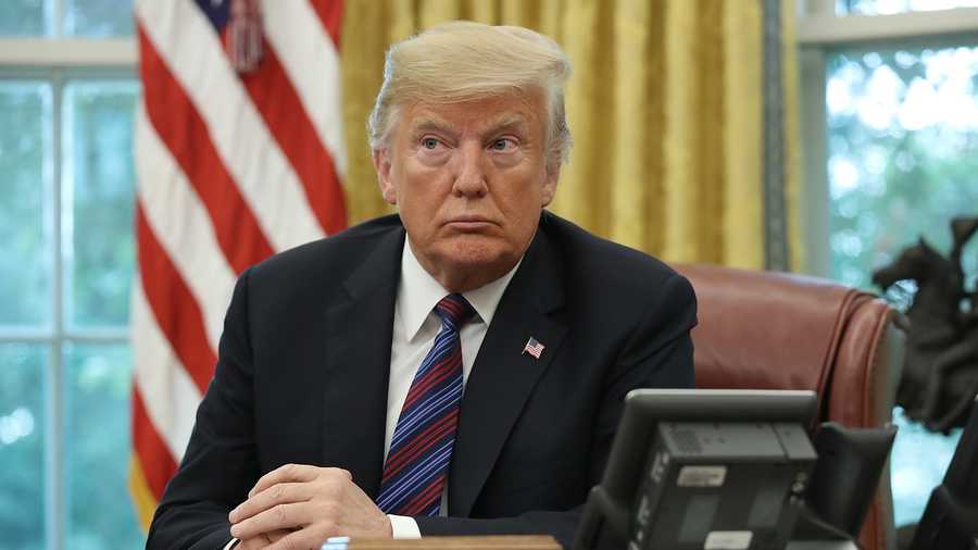 President Donald Trump speaks on the telephone via speakerphone with Mexican President Enrique Pena Nieto in the Oval Office of the White House on August 27, 2018 in Washington, DC.