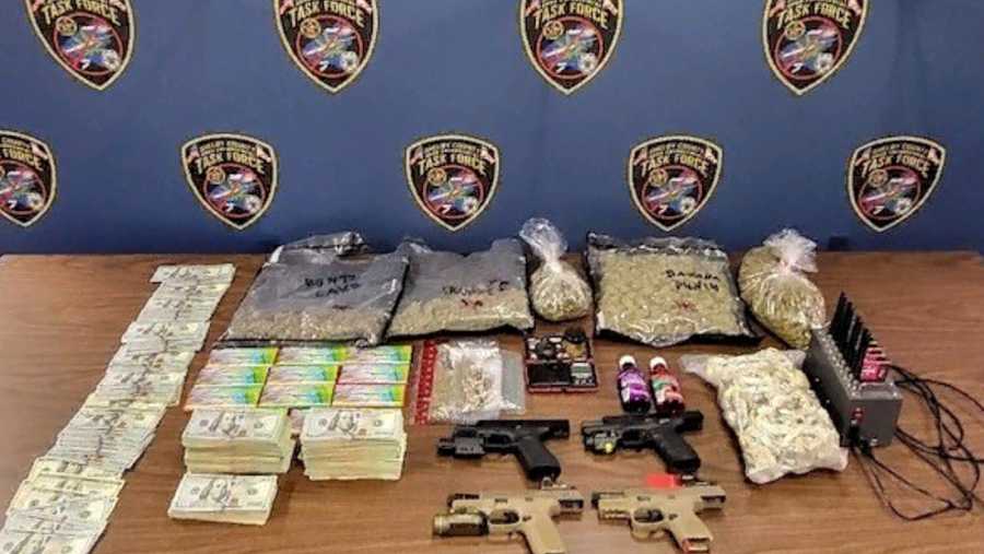 Drugs, guns and cash on a table
