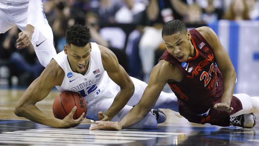 Duke forward Javin DeLaurier (12) beats out Virginia Tech forward Kerry Blackshear Jr. (24) to recover the ball during the first half of an NCAA men's college basketball tournament East Region semifinal Friday, March 29, 2019, in Washington. 