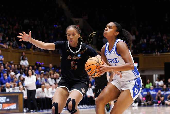 Duke's Riley Nelson, right, drives against Charleston's Tyja Beans (15) during the first half in the first round of the NCAA college basketball tournament, Friday, March 20, 2026, Durham, N.C.