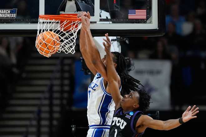 Duke forward Maliq Brown (6) dunks the ball against TCU guard Jayden Pierre (1) during the second half in the second round of the NCAA college basketball tournament, Saturday, March 21, 2026.