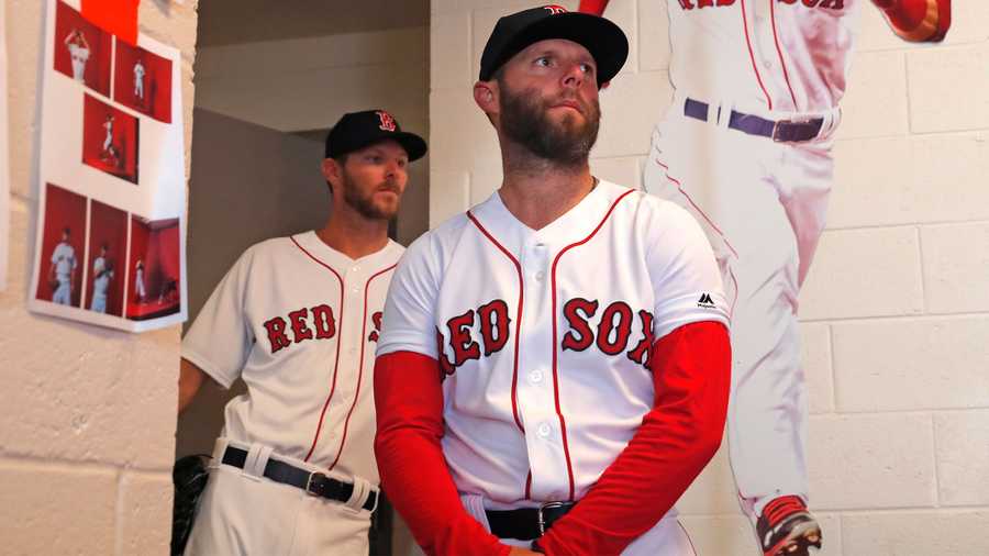 Boston Red Sox second baseman Dustin Pedroia, foreground, and pitcher Chris Sale await their turn for photos during media day at their spring training baseball facility in Fort Myers, Fla., Tuesday, Feb. 19, 2019. (AP Photo/Gerald Herbert)