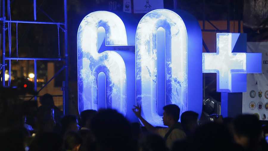 Filipinos gather at the Cultural Center of the Philippines to take part in an Earth Hour activity, a global even that raises awareness on the need to take action on climate change Saturday, March 24, 2018 in suburban Pasay city southeast of Manila, Philippines. 