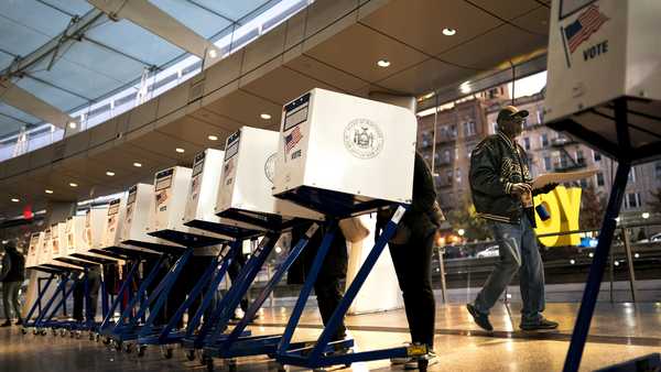 The first voters of the day begin filling out their ballots at a polling site in the Brooklyn Museum as the doors open for the midterm election, Tuesday, Nov. 8, 2022, in the Brooklyn borough of New York.