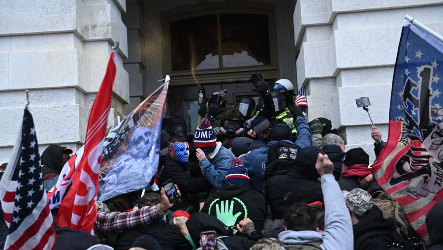 Trump supporters clash with police and security forces as they storm the Capitol in Washington, DC on January 6, 2021.
