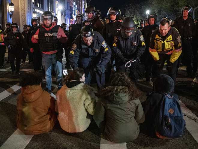 Police move in to arrest pro-Palestinian supporters who were blocking the road after the Emerson College Palestinian protest camp was cleared by police in Boston, Massachusetts, on April 25, 2024. According to Boston Police, 108 people were arrested and 4 officers were hurt as they broke up the camp. (Photo by Joseph Prezioso / AFP) (Photo by JOSEPH PREZIOSO/AFP via Getty Images)