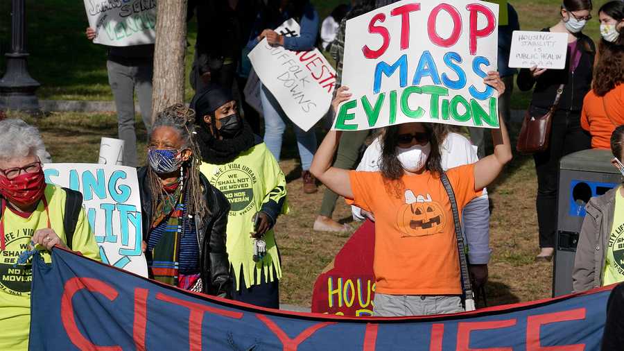 Protesters display placards while calling for support for tenants and homeowners at risk of eviction during a demonstration, Sunday, Oct. 11, 2020, on the Boston Common, in Boston, as the state weathers the ongoing COVID-19 crisis. The event was part of a series of actions across the commonwealth in support of the Guaranteed Housing Stability bill leading up to the expiration Massachusetts' eviction and foreclosure moratorium, which is set to end on Oct. 17. (AP Photo/Steven Senne)