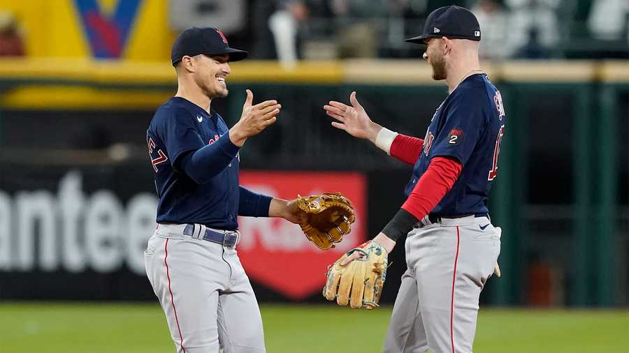 Boston Red Sox's Enrique Hernandez, left, and Trevor Story celebrate the team's 16-3 win over the Chicago White Sox in a baseball game Tuesday, May 24, 2022, in Chicago.
