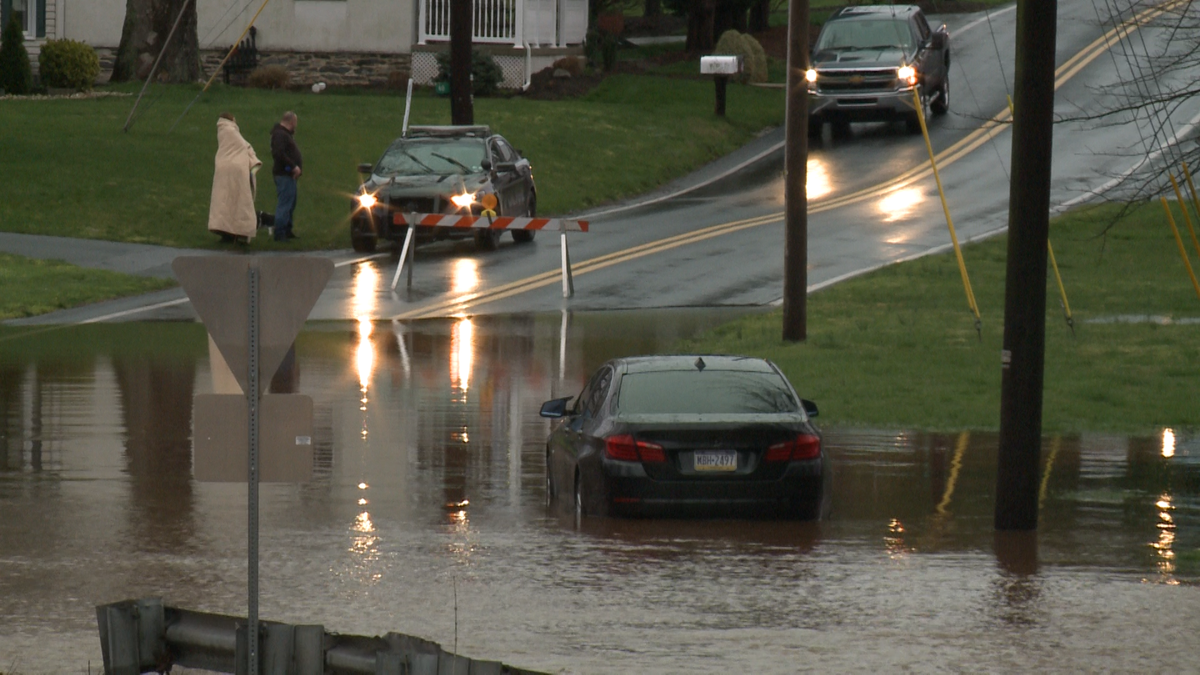 Vehicle stuck in flooded roadway in Ephrata Township