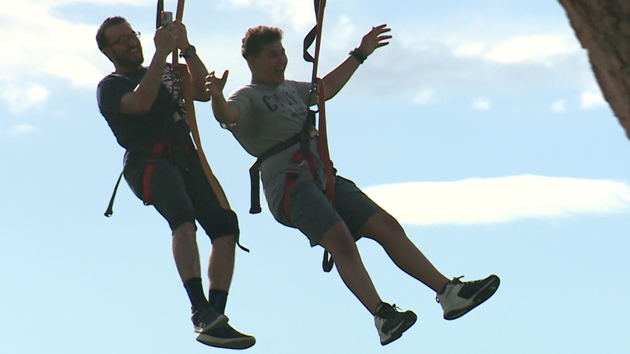 Riders fly on the zipline at the 'Evening in Paradise' celebration