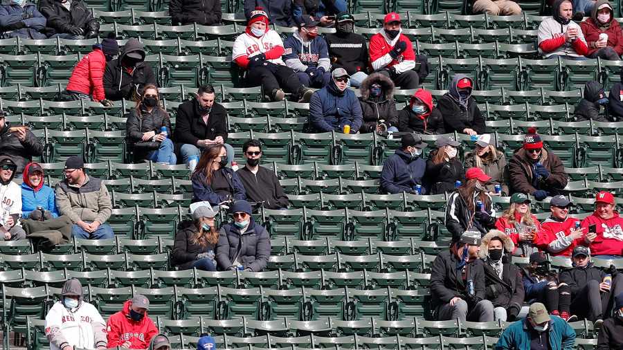 Socially distanced fans sit in the bleachers during the fifth inning of an opening day baseball game between the Boston Red Sox and the Baltimore Orioles, Friday, April 2, 2021, in Boston. (AP Photo)