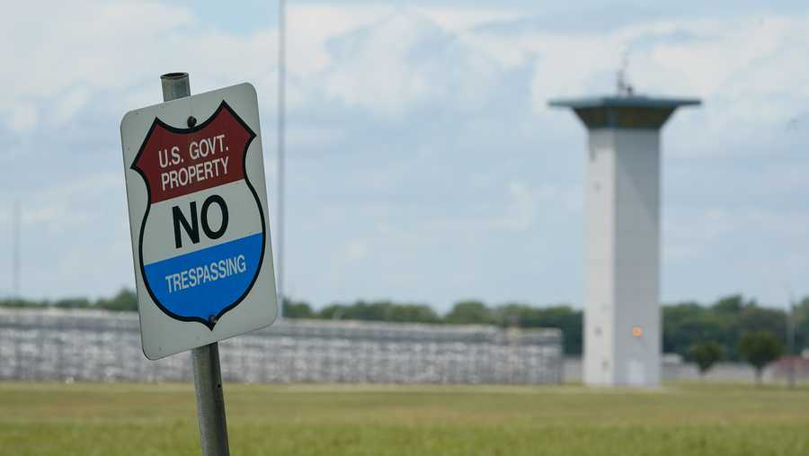 In this Aug. 28, 2020, file photo, a no trespassing sign is displayed outside the federal prison complex in Terre Haute, Ind. A newly released report says the U.S. government for the first time has carried out more civil executions in a year than all states combined as President Donald Trump oversaw a resumption of federal executions after a 17-year pause. (AP Photo/Michael Conroy, File)