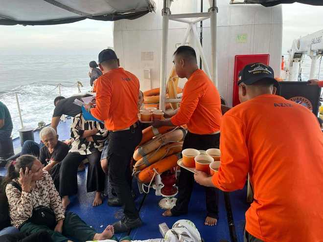 This photo released by the Philippine Coast Guard shows its personnel tending to people who were aboard the M/V Trisha Kerstin 3 around the waters of Baluk-Baluk Island, Basilan, Philippines Monday, Jan. 26, 2026.