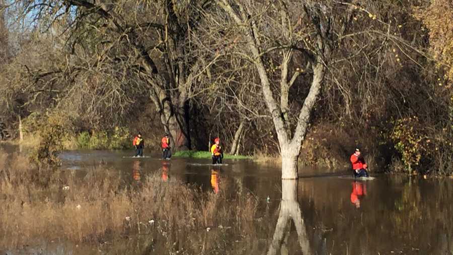 Sacramento firefighters look for a dog stranded in the American River on Sunday, Dec. 18, 2016.
