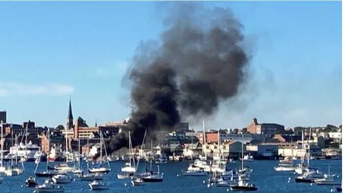 Smoke billows into the air due to a fishing boat fire in Portland Harbor