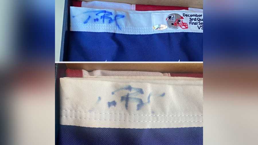 This image provided by Dan Vitale shows a U.S. flag signed by quarterback Tom Brady. Vitale, the owner of the flag, sued the New England Patriots on Wednesday, Oct. 5, 2022, saying the team caused irreparable damage to the flag by improperly displaying it at the team's hall of fame at Gillette Stadium. The suit contends that after the flag had been on display for a couple of months, Brady’s signature written in blue Sharpie had significantly faded, which reduced the flag’s value by as much as $1 million.