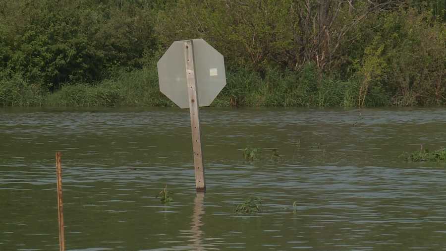 Flood waters reach halfway up stop sign