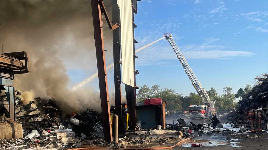 fmfd truck spraying water on fire at metal scrapyard