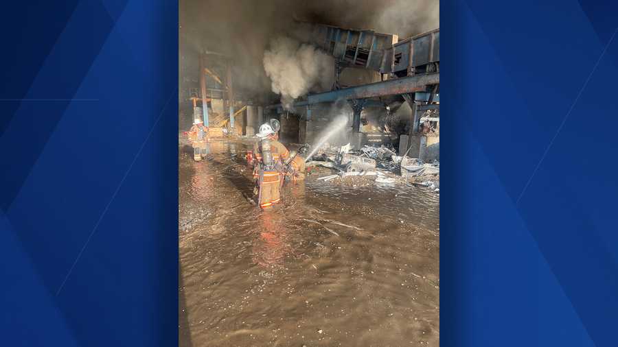 fmfd firefighter spraying water on warehouse fire