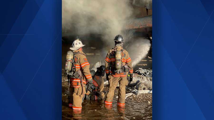 fmfd firefighters putting out flames at warehouse