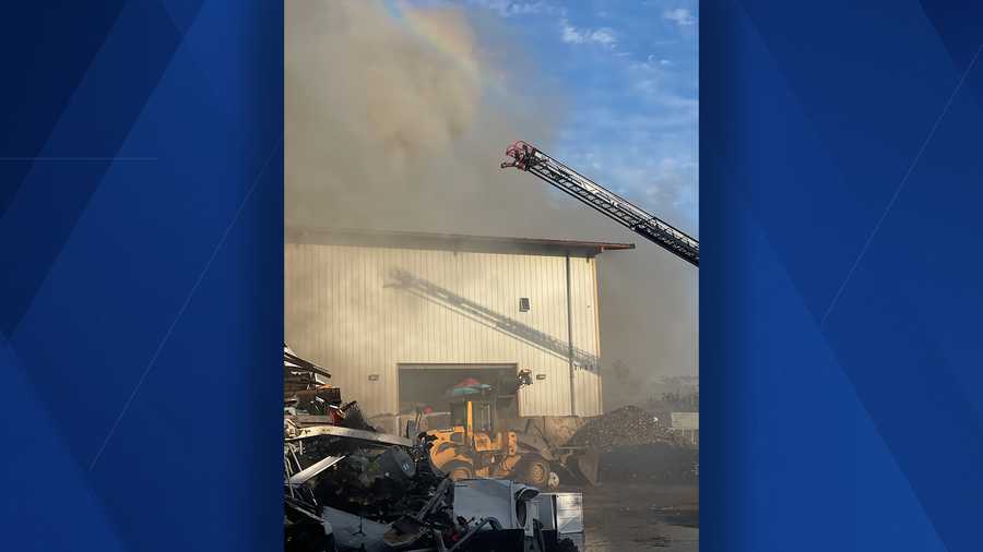 crew with ladder respond to fire in fort myers scrapyard