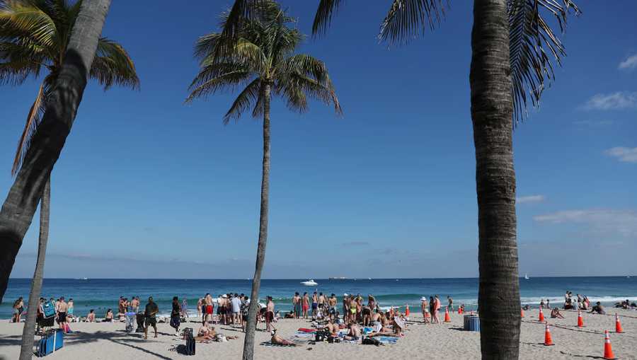 People walk on the beach on March 04, 2021 in Fort Lauderdale, Florida. College students have begun to arrive in the South Florida area for the annual spring break ritual.