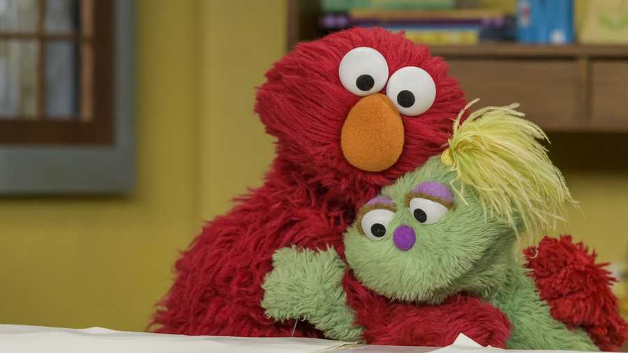 Elmo shares a moment with Karli, a Muppet in foster care, who was recently introduced to "Sesame Street" to support foster children and foster families .