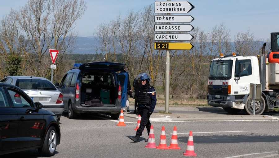 French gendarmes block the access to Trebes, where a man took hostages at a supermarket on March 23, 2018 in Trebes, southwest France.