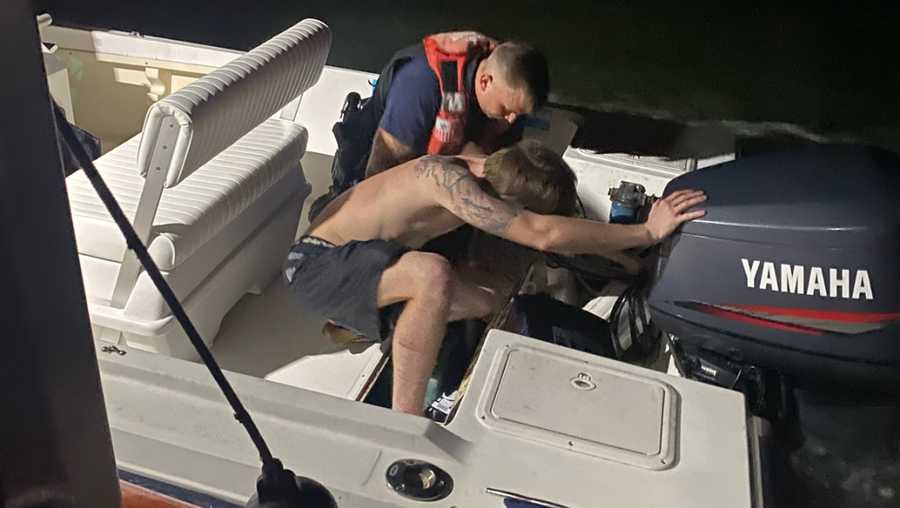 A Coast Guard crew member from Station Tybee assisted a boater in dewatering his around vessel