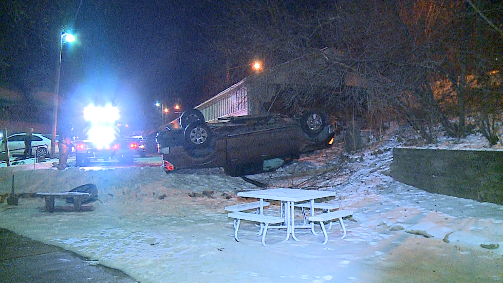 Pickup truck crashes through apartment garage, damages second vehicle