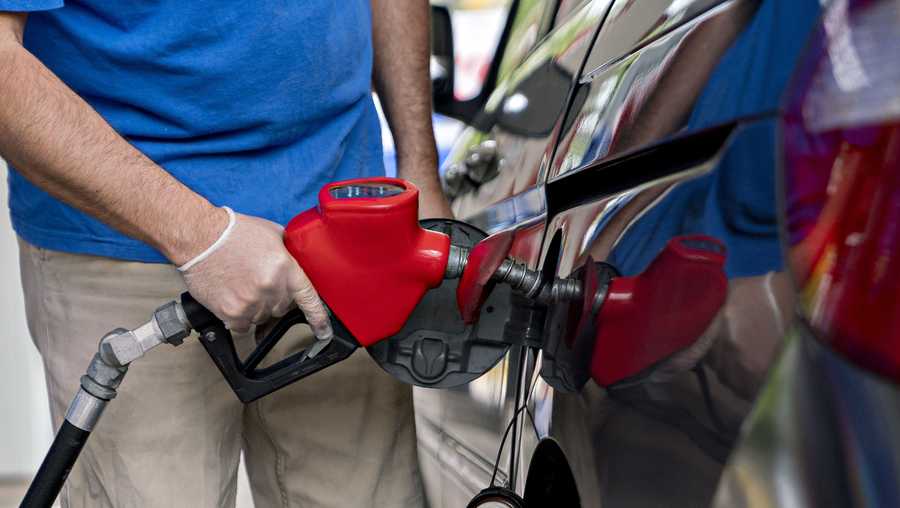 A customer wears a protective glove while refueling a vehicle at an Exxon Mobil Corp. gas station in Arlington, Virginia, U.S., on Wednesday, April 29, 2020.